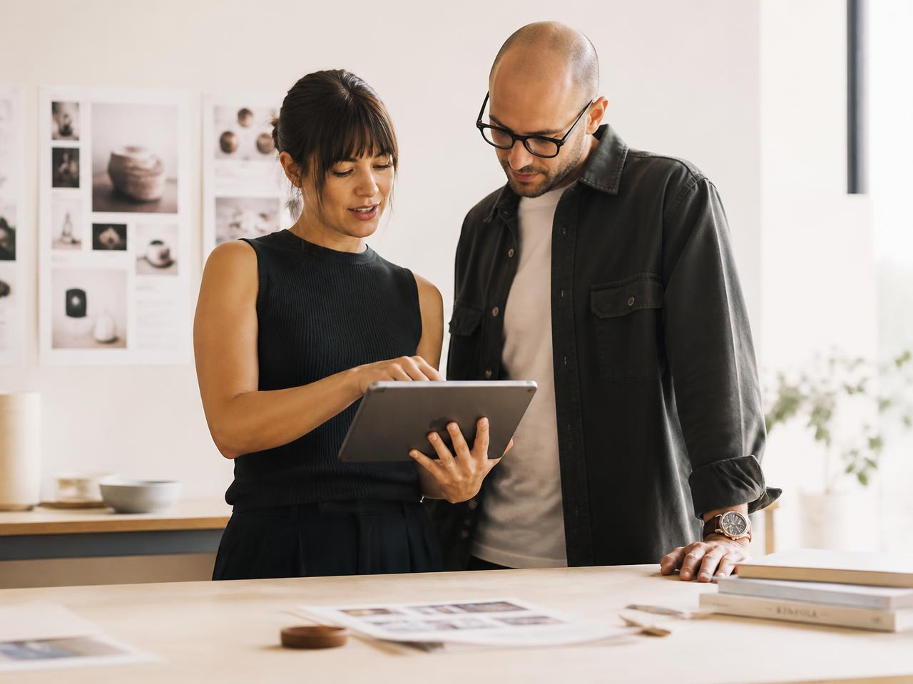 Two brand marketers reviewing a campaign on a tablet